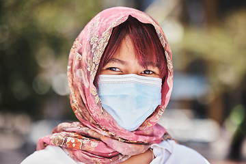 Image showing Muslim, covid and woman in face mask for compliance or safety in a city in Turkey after a medical coronavirus vaccine. Hijab, portrait and Islamic girl standing outdoors in a pandemic with protection