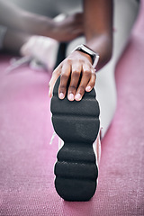 Image showing Wellness, hand or black woman stretching leg in gym for health workout, sports fitness or cardio exercise. Zoom, closeup or athlete girl shoes for warm up, running training or marathon motivation