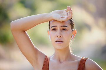 Image showing Woman, fitness and rest, tired and breathing on a running break, listening to music on earphones on summer morning in Australia. Health, exercise and girl runner resting on outdoor workout.