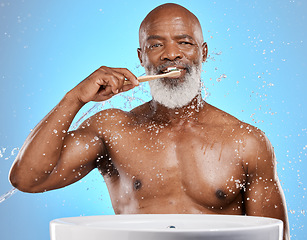 Image showing Dental, brushing teeth and black man with toothbrush for teeth, cleaning with toothpaste for fresh breath and healthy gums against blue background. Water, splash and hygiene with dental care and oral