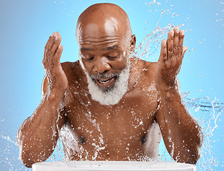 Image showing Man, mature or water splash in face skincare, morning grooming routine or facial cleaning dermatology and healthcare wellness. Person washing, hygiene or self care for black model on blue background