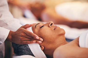 Image showing Hands, head and massage with a woman in a spa for wellness or luxury treatment to relax and rest. Face, zen and stress relied with a senior female relaxing in a health salon for physical therapy