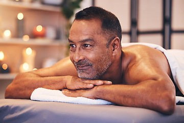 Image showing Man, spa massage and table to relax for zen, calm and physical therapy while on vacation for happiness, health and wellness. Face of male thinking about body treatment at beauty salon with a smile