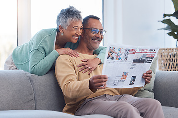 Image showing Love, senior couple and reading newspaper, story or news article in living room home. Retirement, relax time and happy elderly man and woman embrace in house, hugging or cuddle together and bonding.