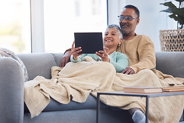 Image showing Tablet, relax and movies with a senior couple on the sofa to relaxing while using an online streaming service. Happy, technology and internet with a mature man and woman under a blanket at home