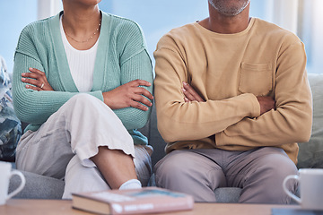 Image showing Angry, upset and annoyed with a couple sitting arms crossed on a sofa in the living room of their home. Arguing, disagreement and anger with a man and woman thinking about divorce or separation