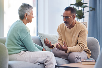 Image showing Couple, talking and conversation during fight on sofa about marriage problems, conflict and communication. Divorce, argument and frustrated relationship of mature man, woman and sad partner in lounge