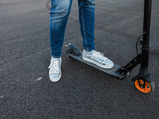 Image showing Woman riding an electric scooter