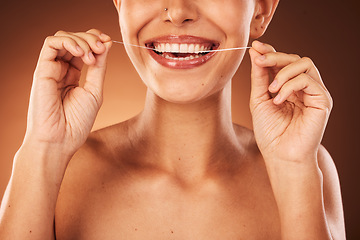 Image showing Teeth, zoom and woman with floss for dental cleaning, teeth whitening and healthy mouth protection in studio. Smile, wellness or hands of girl flossing with thread for natural tooth shine, self care