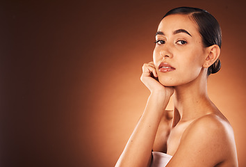 Image showing Cosmetics, skincare and young woman for wellness, heath and confident with brown studio background. Portrait, female and girl with makeup, natural beauty and organic facial for smooth and clear skin.