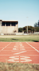 Image showing Empty stadium, sports and race track with numbers for start position in athletics, marathon or competition. Ground, arena and event field for running, sprint or cardio exercise, workout or training.