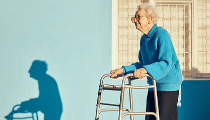 Image showing Senior, walker and woman in a city with a disability, osteoporosis or arthritis walking with wall mockup. Relax fitness from leg rehabilitation after surgery with a elderly female walk for health