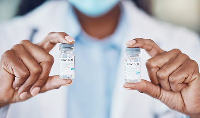 Image showing Doctor hands, covid vaccine medicine bottle and serum for risk, healthcare and wellness safety. Closeup corona virus medical worker, pharmaceutical innovation and scientist drug test cure of covid 19