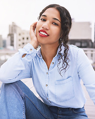 Image showing Travel, fashion and woman student relax in an urban city, excited and carefree while sitting outdoors. Portrait of a young fashion designer exploring a new town for design, trends and inspiration