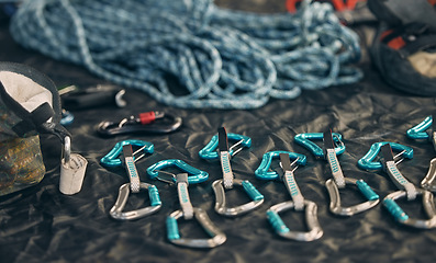 Image showing Rope safety, climbing and rock mountain sports equipment to be safe and secure. Sports tool setup zoom of carabiner an hook tools for an outdoor, security and adventure experience in the mountains