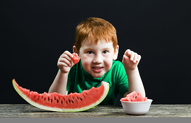 Image showing boy eats a red watermelon