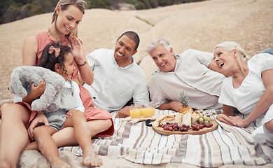 Image showing Big family, beach picnic and happiness while enjoying healthy snacks and food together with a child, interracial parents and grandparents. Travel, fun and bonding with men, women and girl in summer