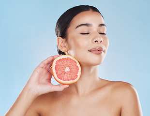 Image showing Skincare, wellness beauty woman with grapefruit in hand with healthcare, cosmetic health and face model in studio. Portrait of girl skin, healthy fruit diet with vitamins and nutrition.