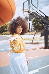 Image showing Sport, fitness and training basketball player catch ball, looking confident and tough on court. Portrait sporty woman enjoying time outdoors with favorite hobby, spending weekend on healthy activity