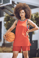 Image showing Basketball court, woman player or sports person with afro looking serious at training, workout and exercise or competition ball game. Fitness portrait of healthy athlete with motivation or vision