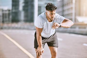 Image showing Fitness, tired and runner checking watch for running speed, pace and time in routine workout, exercise and city training. Fit, active and healthy man monitoring wellness, endurance and cardio health