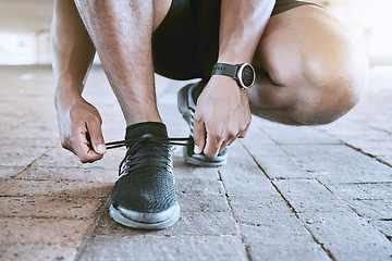 Image showing Shoes, fitness and exercise with a sports man tying his laces for a cardio and endurance workout in the city. Training, running or exercise and an athlete with a motivation for health and wellness