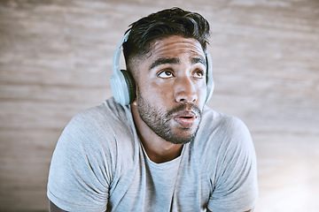 Image showing Training, sports and fitness with athlete listen to music on headphones, getting ready to exercise. Sporty male on break, streaming motivation podcast online, doing breathing exercises before workout