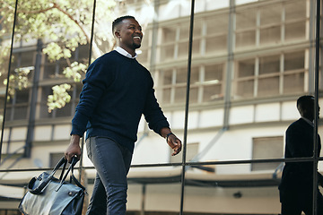 Image showing Fashion, travel and corporate employee or businessman traveling and walking out of a building or airport in a city. African American worker or traveler in an urban town with good style going to hotel