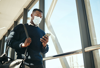 Image showing Business, travel and covid with a businessman on his phone about to board an airplane flight. Corporate professional black man texting about work and walking in an airport on an international trip.