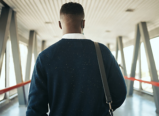 Image showing Travel for business at airport, corporate worker walking to plane with luggage. Ceo work trips journey, boarding terminal and back portrait of stylish african business man leaving city