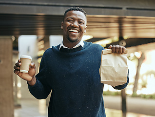 Image showing Business man with food and coffee in city, eating fast food during work and hungry at lunch time in urban town. Portrait of corporate worker with paper bag, tea for drink and working with smile