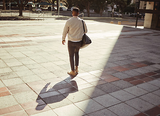 Image showing Business, travel and city with a young man walking outdoors against an urban background in the day. Entrepreneur or employee looking for work, a job or ready to start a career on a summer morning