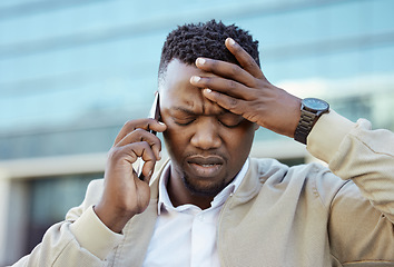 Image showing Stressed, pain and tired business man on an annoying phone call outdoors in a city feeling angry and disappointed. Frustrated, unhappy or sick entrepreneur with a headache or migraine