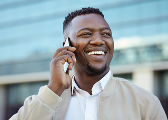 Image showing Man on a phone call outside a building in the street receiving news after winning online game. Happy guy getting corporate promotion at work. Winner excited about success and victory on smartphone.