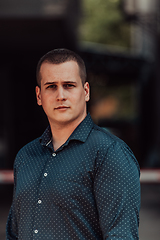 Image showing A portrait of a modern man, exuding confidence and style, against an outdoor backdrop, showcasing his charisma and fashionable demeanor.