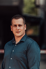 Image showing A portrait of a modern man, exuding confidence and style, against an outdoor backdrop, showcasing his charisma and fashionable demeanor.