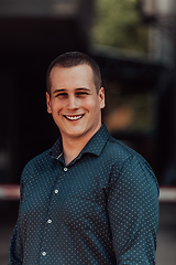 Image showing A portrait of a modern man, exuding confidence and style, against an outdoor backdrop, showcasing his charisma and fashionable demeanor.