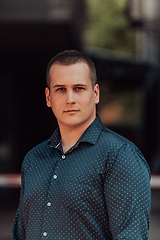 Image showing A portrait of a modern man, exuding confidence and style, against an outdoor backdrop, showcasing his charisma and fashionable demeanor.