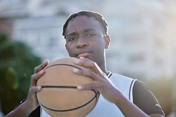 Image showing Basketball, cool and a tough player training for a game on a basketball court. Portrait of a serious professional athlete focused on his sport career, looking ready, powerful and assertive