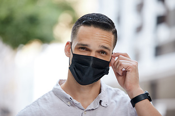 Image showing Freedom, end of covid and man removing face mask after corona virus with bokeh urban city. Trust and compliance in post covid 19 portrait or headshot of young person free after getting vaccine