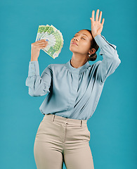 Image showing Woman showing off money, looking rich with cash prize and winning the lottery while standing against a blue studio background. Female billionaire holding bank notes and looking confident with salary