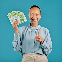 Image showing Thumbs up of a woman happy with financial success holding money and cash to budget. Portrait of a young female proud about successful banking finance, investment profit and salary savings growth