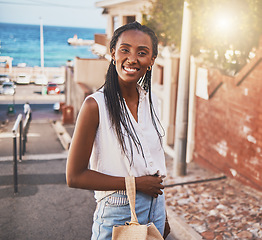 Image showing Happy smile black woman on vacation in city by sea or ocean water port side on sunshine summer holiday travel. Portrait of joy, excited and smiling black girl person on sun flare urban outdoor street