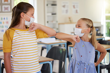 Image showing Covid greeting, elbow bump and mask wearing with little girl students standing in class at school. Study, education and safety in a classroom with a female child and her friend bumping elbows