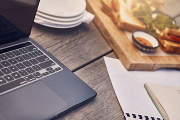 Image showing Restaurant, cafe or coffee shop table as a workspace with a laptop, papers and food in the morning. Background or closeup of a remote and wooden work desk outdoors at a fast food place