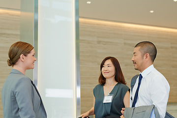 Image showing Business people, hotel concierge and check in at luxury hospitality, corporate travel and asian people. Company employee at receptionist for work convention, travelling and staff book for conference