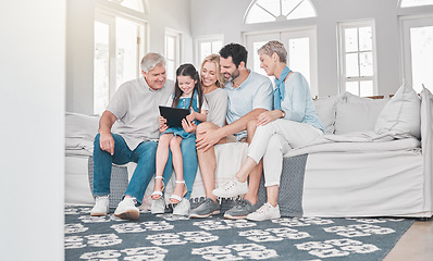 Image showing Family, children and tablet with parents, grandparents and girl on a sofa in the living room of their home together. Love, kids and technology with a woman, man and daughter at relatives for a visit