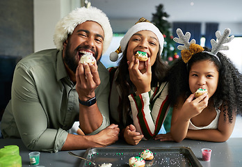 Image showing Christmas, family and cookie eating of a mother, father and girl in a home kitchen with happiness. Holiday baking, celebration and family home portrait of a mom, dad and child together happy