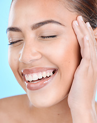 Image showing Woman, face and beauty skincare, happy smile with healthy teeth, dental wellness and natural makeup in blue studio background. Health, luxury and happy beautiful young girl with smile and clean skin