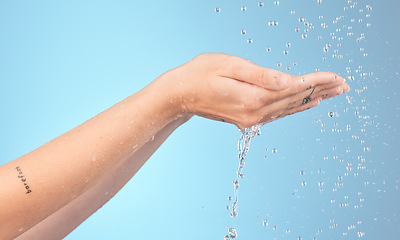 Image showing Hands, cleaning and woman in shower for water splash, wellness and hygiene against blue background mockup. Hands, water and girl model relax with beauty splash, washing and grooming on studio mock up